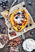 Vegan sweet potato with sweet coconut topping and blueberries