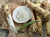 Horseradish root, grated horseradish and a horseradish leaf