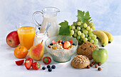 A healthy breakfast with muesli, yoghurt, fruit, fruit juice, milk, wholemeal bread