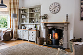 Living room with fireplace and country-style shelving unit