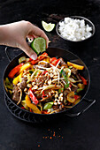 Beef wok with bell peppers, leek and sprouts