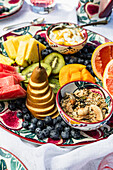 Breakfast tray with fresh fruit, muesli and yoghurt