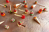 Party canapés: Melon skewers, tuna fish bites and caviar in waffle cones