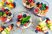 Yoghurt with granola, fresh berries and fruit skewers