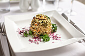 Spinach risotto timbale with pine nuts