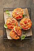 Quick English muffin pizzas with salami and ham