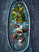 Spinach and goat's cheese roulade with orange dates and wild herbs