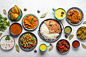 Indian ethnic food buffet on white concrete table