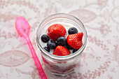 Yoghurt with granola, strawberries, raspberries and blueberries
