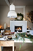 Christmas coffee table with rosemary branches in front of fireplace