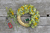Summer wreath tied on a straw wreath base (hydrangea, poppy seed heads, tansy, Queen Anne's lace)