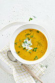 Light carrot soup with sour cream, dill, and marjoram