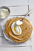 Wholewheat spelt pancakes with yogurt cream and maple syrup