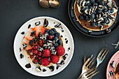 Pancakes with chocolate biscuits and berries