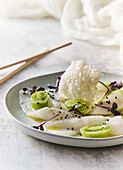 Cod ceviche with rice paper chips and mini kiwi