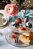 Various pastries on glass etagere
