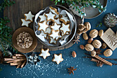Cinnamon stars in tin can, star anise, cinnamon sticks, nutcracker and pine cones