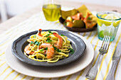 Shrimps with spaghetti on tin plate
