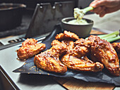 Buffalo chicken wings cooked in a Dutch oven