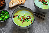 Pea soup with fried tofu, red chili pepper and spring onions