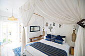 Cozy airy bedroom with blue pillows
