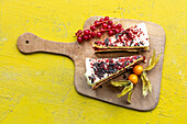 Fruity cream cheese cake - two pieces on a wooden board