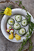 Cucumbers, tomatoes and evening primrose flowers with feta cheese