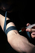 Heroin user injecting drug