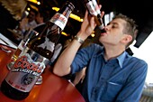 Young man drinking a bottle of beer