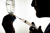 Doctor preparing syringe