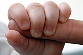 Baby gripping a finger