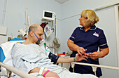 Nurse monitoring patient's heart rate and blood pressure