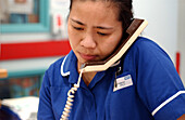 Nurse using hospital telephone