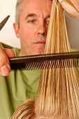 Young woman having her hair cut