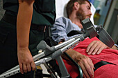 Paramedic holding patient's crutches