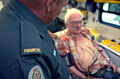 Paramedic monitoring a patient