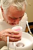 Man rinsing mouth after dental treatment