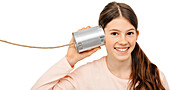 Girl with tin can to her ear