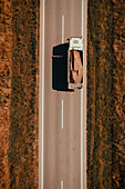 Lorry on road in winter, aerial view
