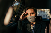 Anxious businesswoman sitting inside a car