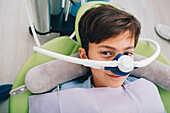 Child with nitrous oxide mask at dentist