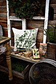 Rustic seating area with cushions and Christmas gifts outside wooden house