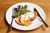 Poached eggs, smoked salmon on toast with a salad