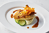 Skin on chicken breast with mashed potato and courgettes