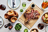 Salted roast rib of beef with yorkshire puddings, brocolli, carrots and glasses of wine