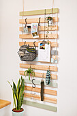 Slatted wood base wall hook with assorted plants and items