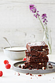 Chocolate, hazelnut and raisin brownies with raspberries