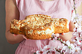 Hands holding Colomba di Pasqua (Traditional Italian Easter dove cake with almonds)