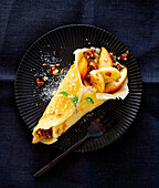 Crêpes filled with baked apple, sultanas and nuts