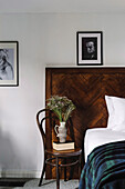 Coffee house chair as bedside table in front of bed head with herringbone pattern